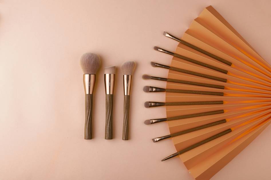 Close-up of various makeup applicators arranged neatly on a vanity table