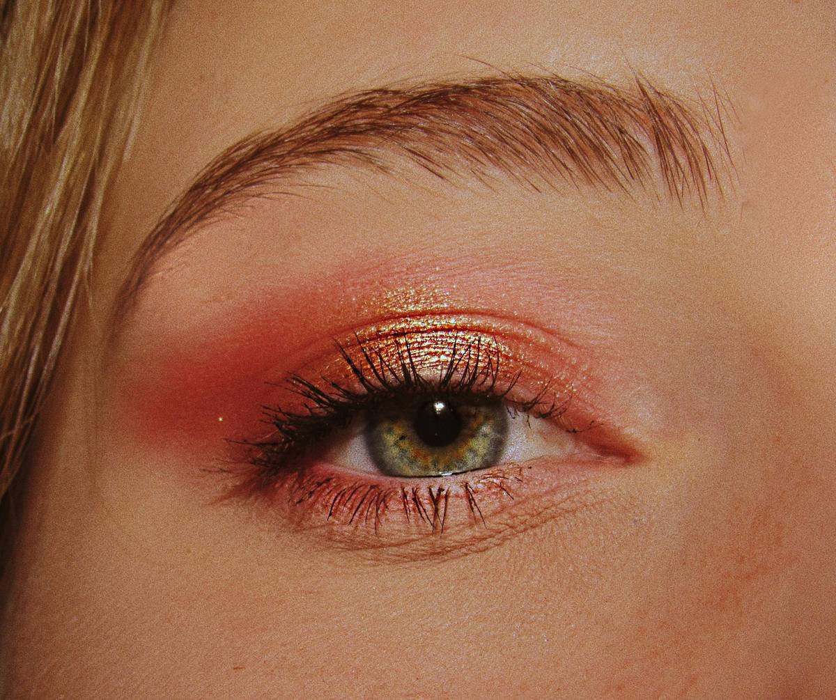 Woman using a makeup setting aid spray to lock in foundation and prevent midday shine